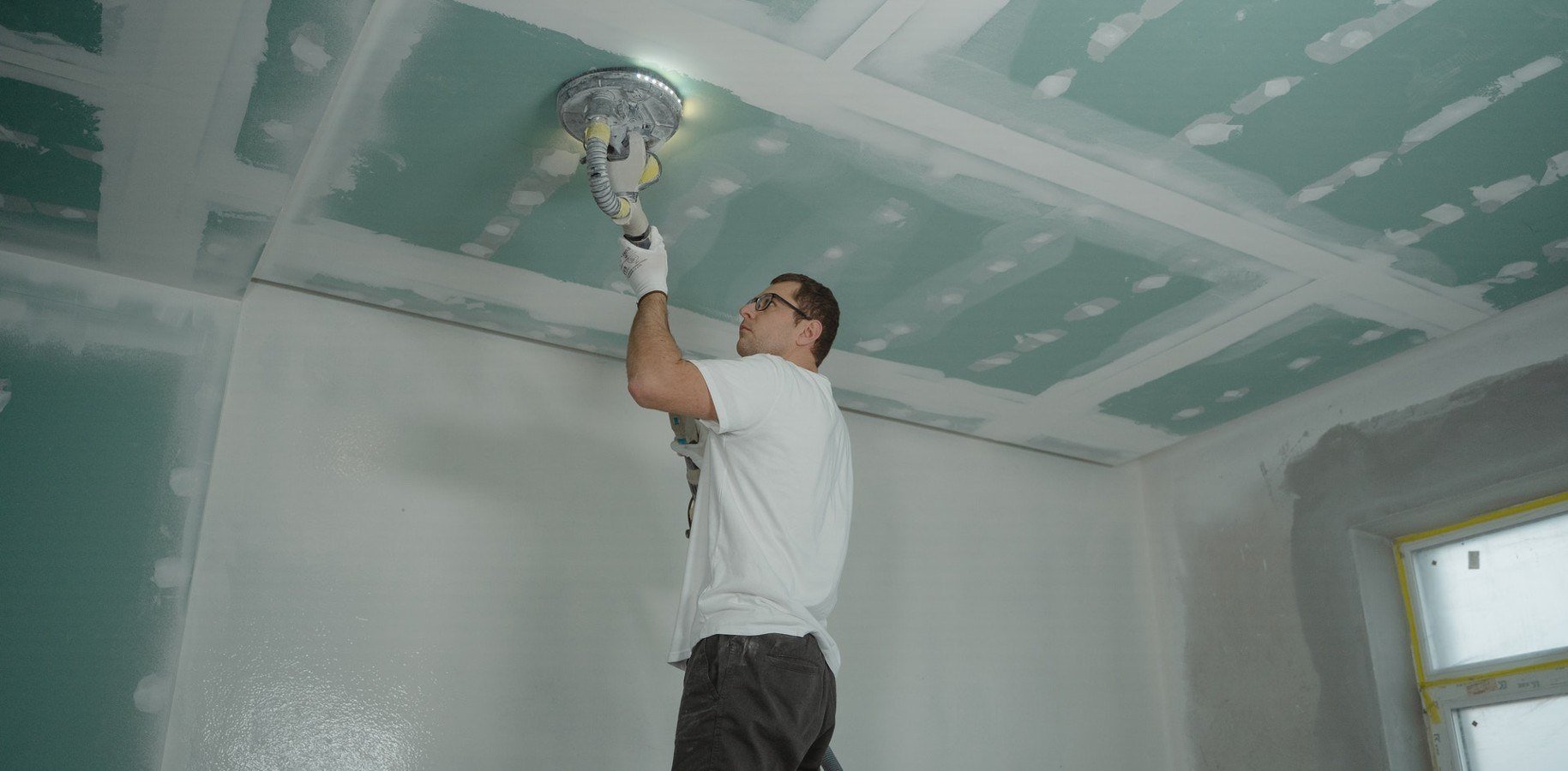 guy fixing ceiling